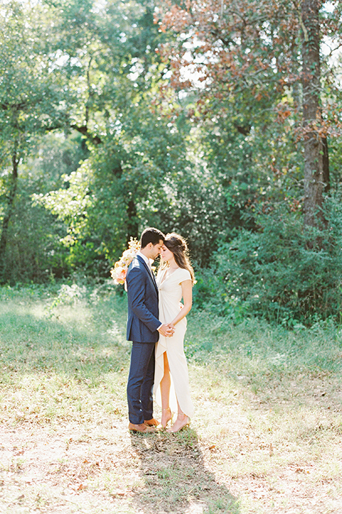  ruffled shoot in texas – bride in a romantic casual wrap dress and the groom in a blue suit with a white long tie