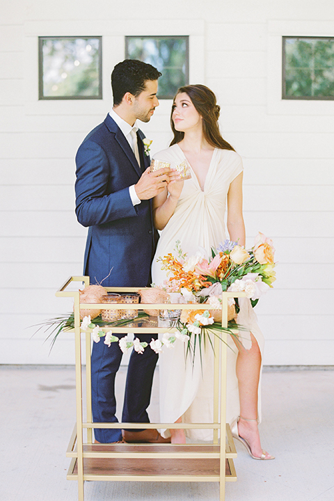  ruffled shoot in texas – bride in a romantic casual wrap dress and the groom in a blue suit with a white long tie