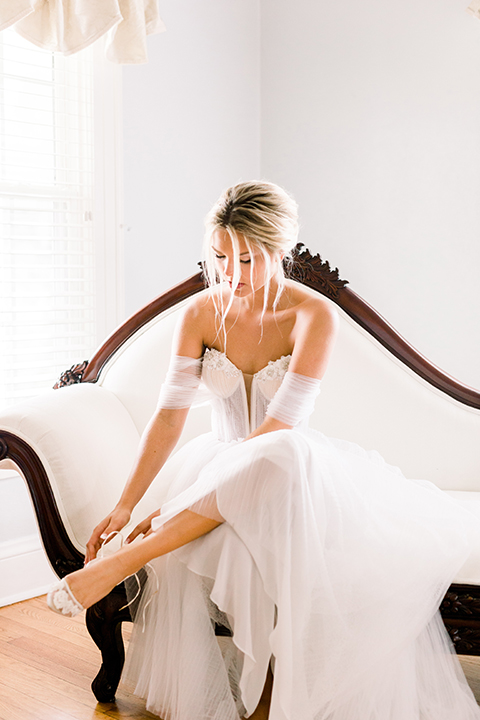  bride in a flowing gown with an off the shoulder detail