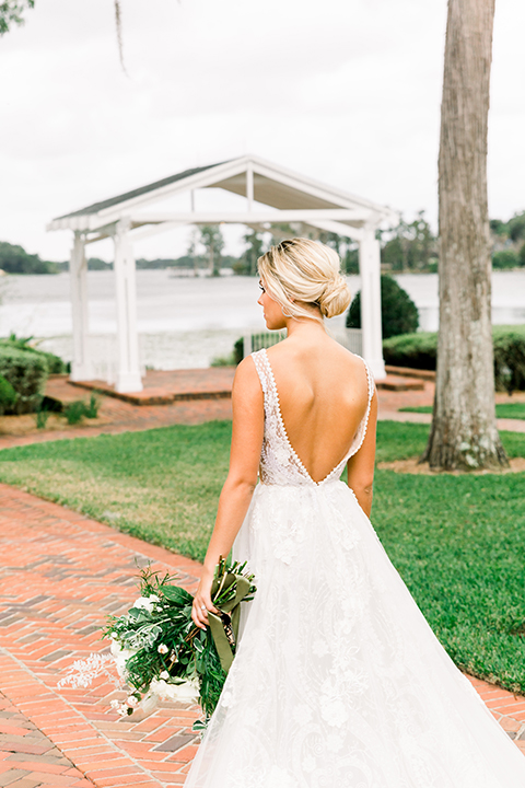  bride in a flowing gown with an off the shoulder detail 