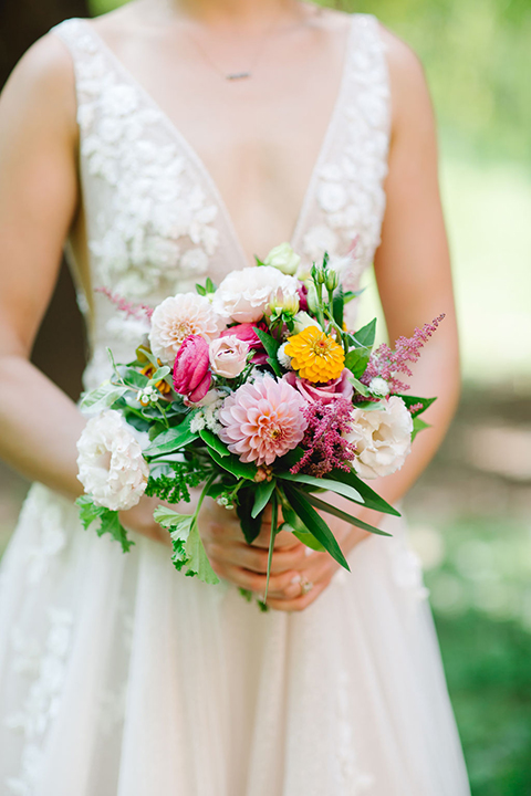  bride in a white a line gown with colorful flowers 