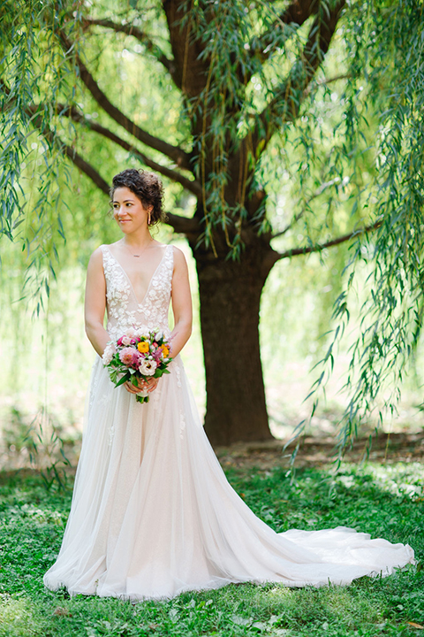  bride in a white a line gown with colorful flowers 