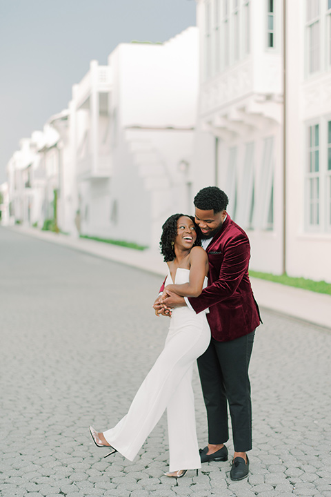  alys beach anniversary shoot with the groom in a burgundy velvet tuxedo and the bride in a jumpsuit 