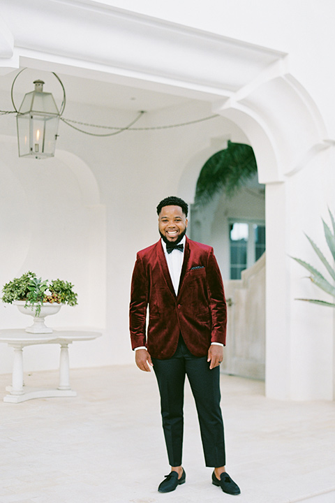  alys beach anniversary shoot with the groom in a burgundy velvet tuxedo and the bride in a jumpsuit 
