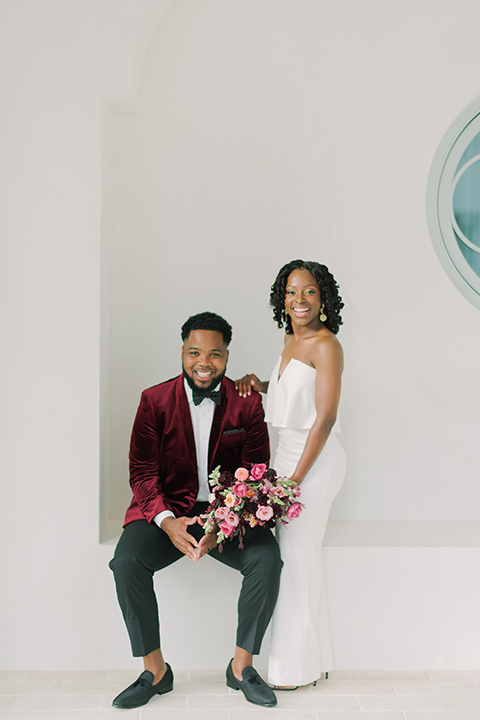  alys beach anniversary shoot with the groom in a burgundy velvet tuxedo and the bride in a jumpsuit 