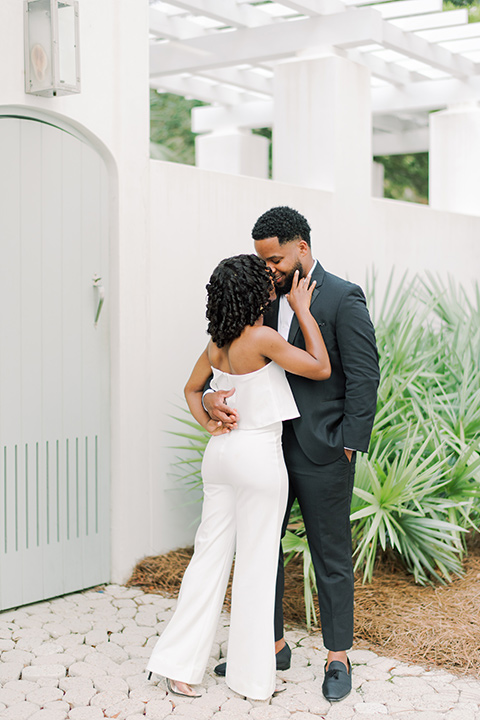  alys beach anniversary shoot with the groom in a burgundy velvet tuxedo and the bride in a jumpsuit 