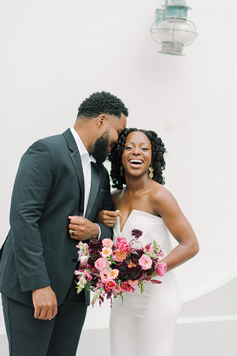  alys beach anniversary shoot with the groom in a burgundy velvet tuxedo and the bride in a jumpsuit 