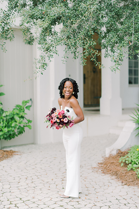  alys beach anniversary shoot with the groom in a burgundy velvet tuxedo and the bride in a jumpsuit 