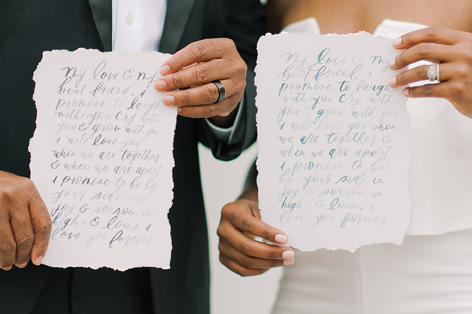  beach style wedding with the groom in a café brown coat and navy pant 