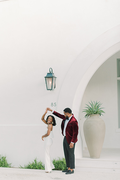  alys beach anniversary shoot with the groom in a burgundy velvet tuxedo and the bride in a jumpsuit 