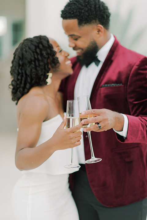  alys beach anniversary shoot with the groom in a burgundy velvet tuxedo and the bride in a jumpsuit 