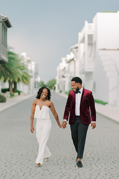  alys beach anniversary shoot with the groom in a burgundy velvet tuxedo and the bride in a jumpsuit 