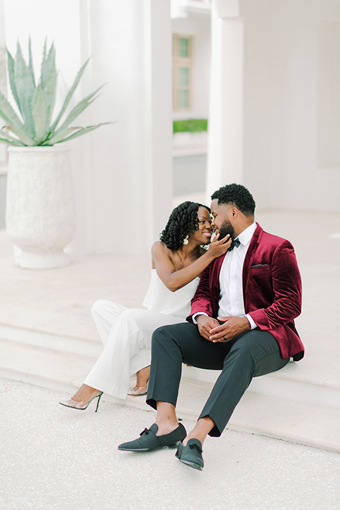  alys beach anniversary shoot with the groom in a burgundy velvet tuxedo and the bride in a jumpsuit 