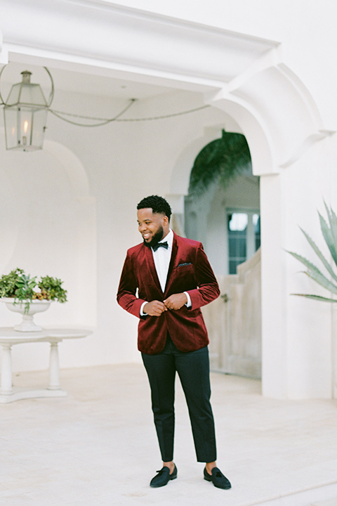  alys beach anniversary shoot with the groom in a burgundy velvet tuxedo and the bride in a jumpsuit 
