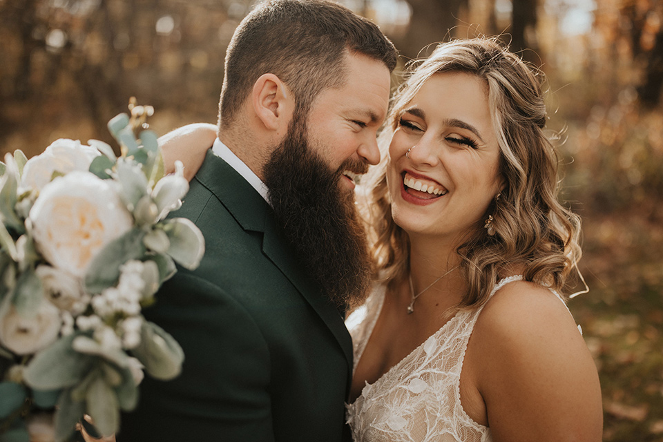  bride in a modern boho gown and the groom and groomsmen in green suits and the bridesmaids in blush gowns 