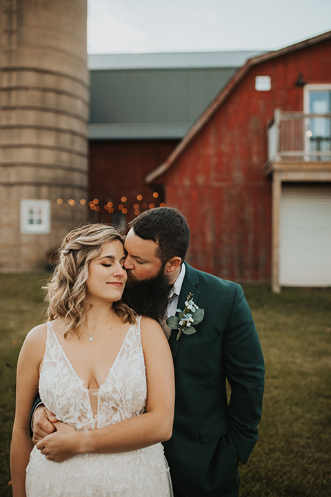  bride in a modern boho gown and the groom and groomsmen in green suits and the bridesmaids in blush gowns 