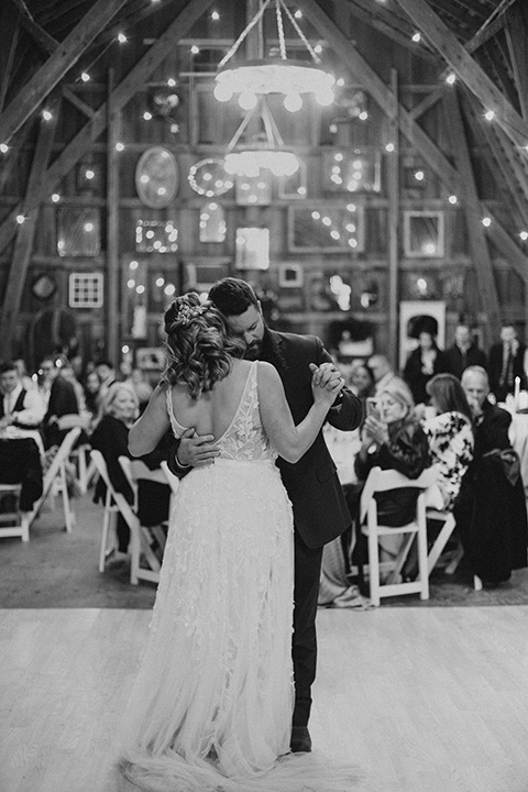  bride in a modern boho gown and the groom and groomsmen in green suits and the bridesmaids in blush gowns 