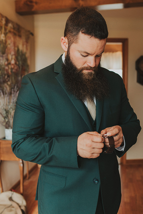  bride in a modern boho gown and the groom and groomsmen in green suits and the bridesmaids in blush gowns 