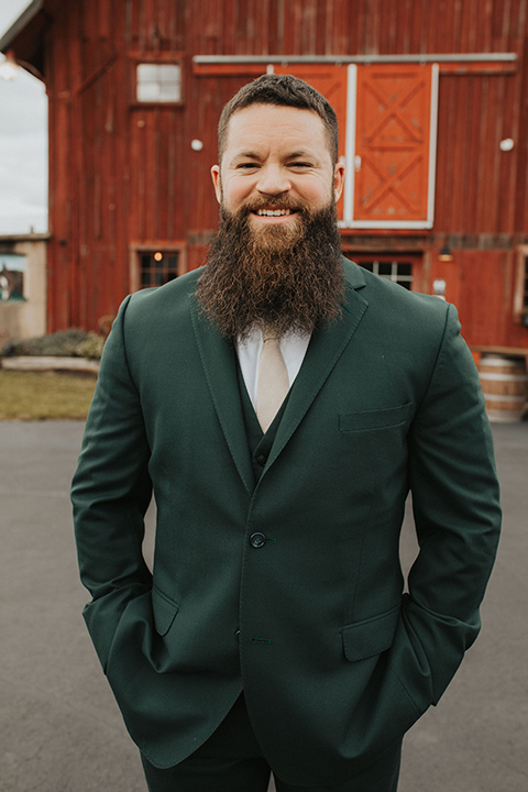  bride in a modern boho gown and the groom and groomsmen in green suits and the bridesmaids in blush gowns 