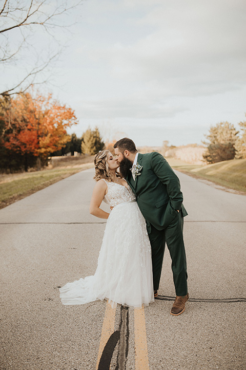  bride in a modern boho gown and the groom and groomsmen in green suits and the bridesmaids in blush gowns 