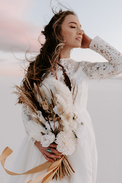  a national park elopement with the groom in a caramel brown suit and the bride in a lace gown 