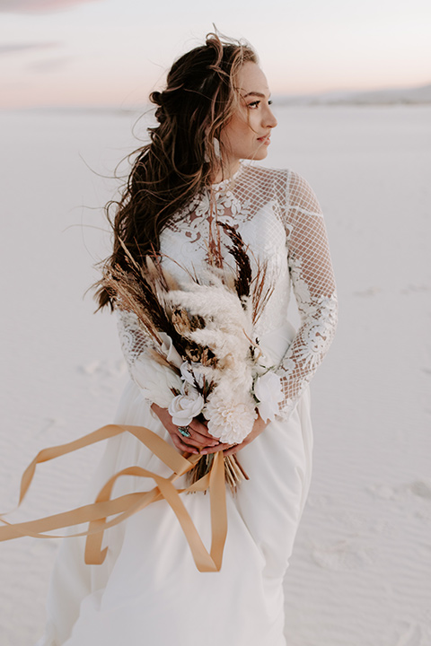  a national park elopement with the groom in a caramel brown suit and the bride in a lace gown 