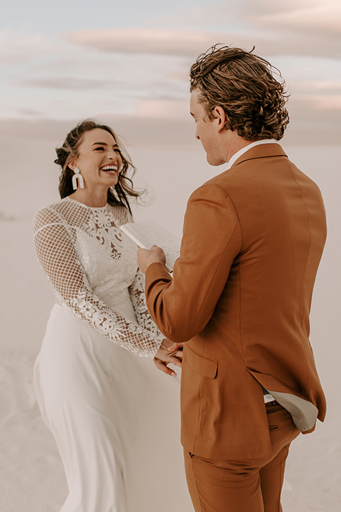  a national park elopement with the groom in a caramel brown suit and the bride in a lace gown 