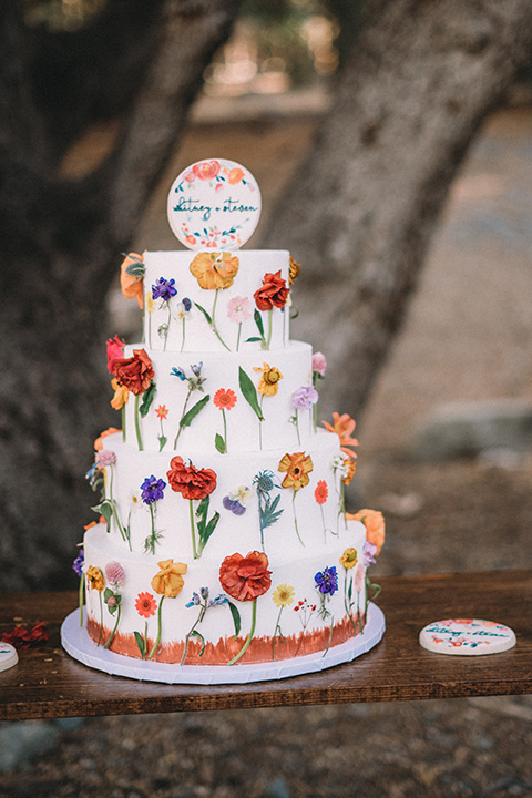  camp wrightwood wedding with the groom in a green suit and floral tie and the bride in a ballgown with lace sleeves 