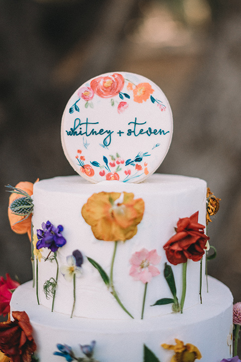  camp wrightwood wedding with the groom in a green suit and floral tie and the bride in a ballgown with lace sleeves 