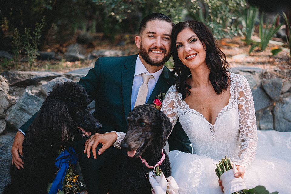  camp wrightwood wedding with the groom in a green suit and floral tie and the bride in a ballgown with lace sleeves 