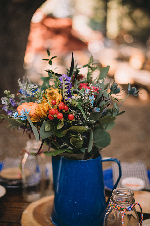  camp wrightwood wedding with the groom in a green suit and floral tie and the bride in a ballgown with lace sleeves 