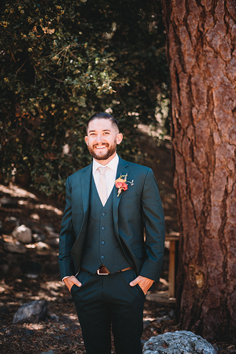  camp wrightwood wedding with the groom in a green suit and floral tie and the bride in a ballgown with lace sleeves 