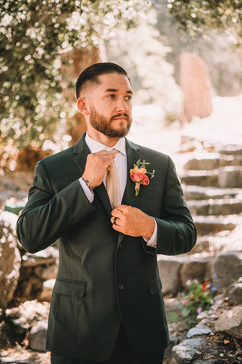  camp wrightwood wedding with the groom in a green suit and floral tie and the bride in a ballgown with lace sleeves 