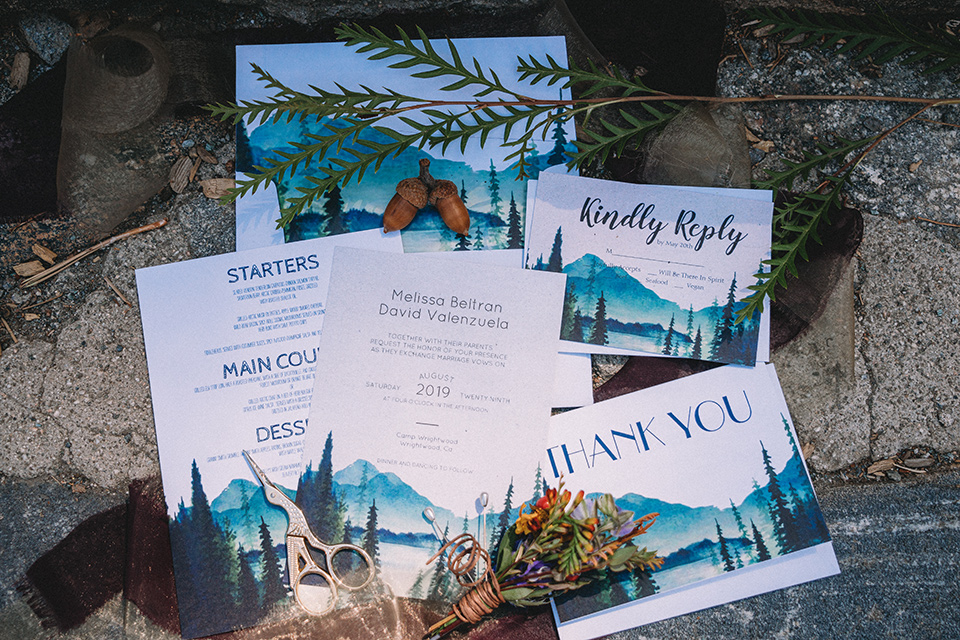  camp wrightwood wedding with the groom in a green suit and floral tie and the bride in a ballgown with lace sleeves 