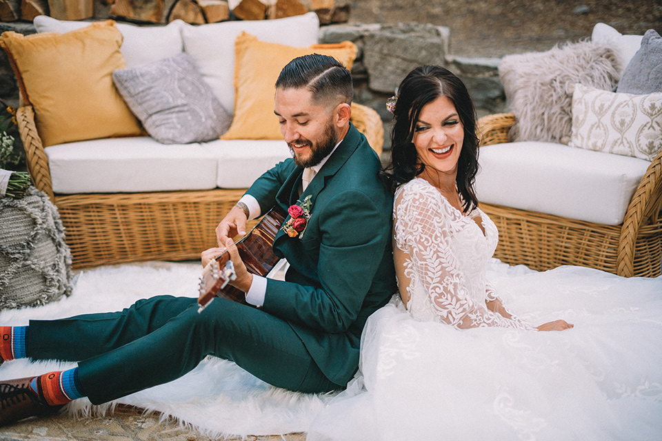  camp wrightwood wedding with the groom in a green suit and floral tie and the bride in a ballgown with lace sleeves 