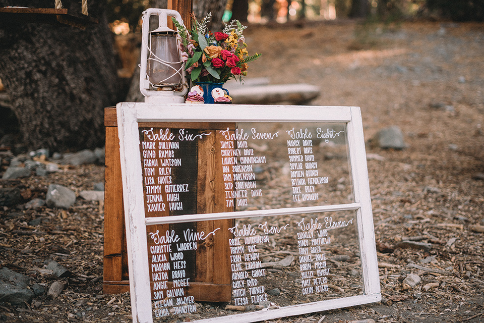  camp wrightwood wedding with the groom in a green suit and floral tie and the bride in a ballgown with lace sleeves 