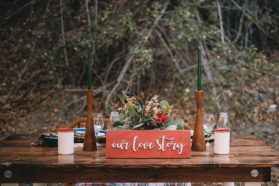  camp wrightwood wedding with the groom in a green suit and floral tie and the bride in a ballgown with lace sleeves 