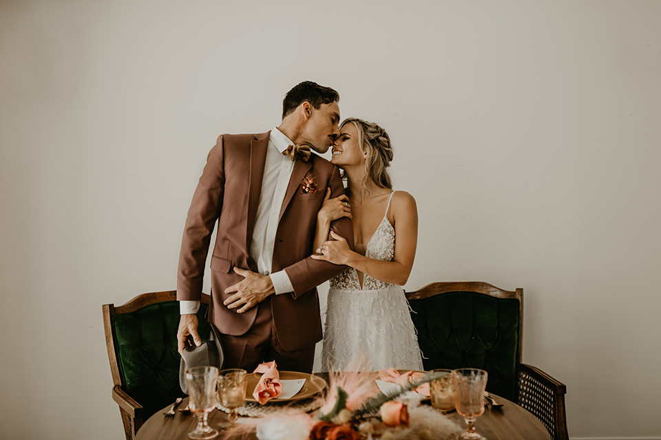  wedding at the colony house with bohemian touches and the groom in a rose pink suit and wide brimmed hat 