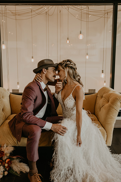  wedding at the colony house with bohemian touches and the groom in a rose pink suit and wide brimmed hat