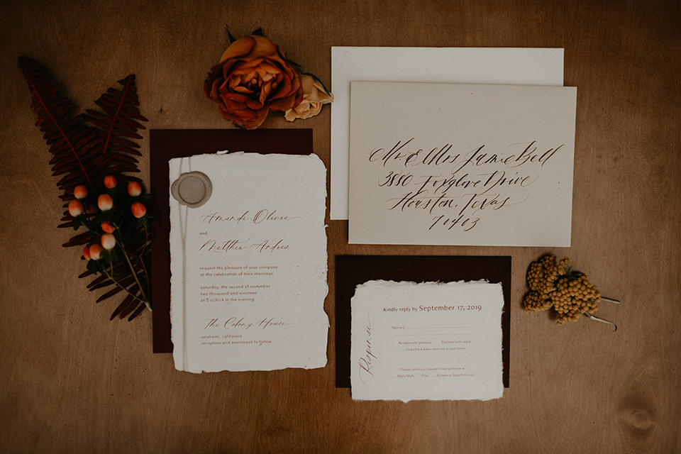  wedding at the colony house with bohemian touches and the groom in a rose pink suit and wide brimmed hat 