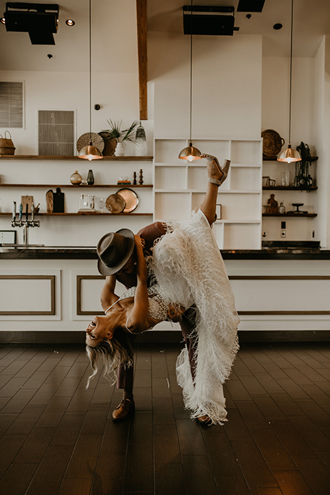  wedding at the colony house with bohemian touches and the groom in a rose pink suit and wide brimmed hat