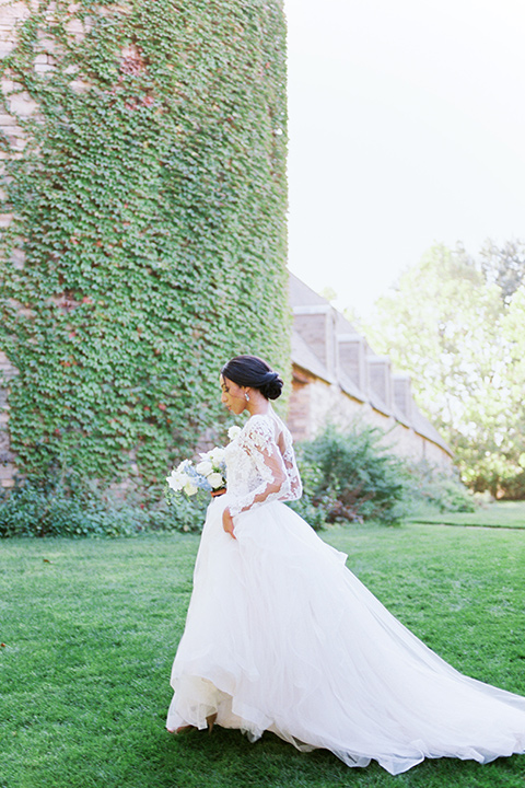  a gold and navy wedding at kestrel park with the groom in a navy tuxedo and the bride in a lace ballgown with long sleeves 