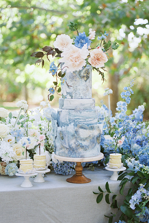  a gold and navy wedding at kestrel park with the groom in a navy tuxedo and the bride in a lace ballgown with long sleeves 