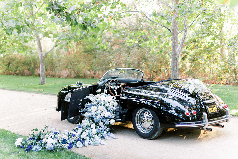  a gold and navy wedding at kestrel park with the groom in a navy tuxedo and the bride in a lace ballgown with long sleeves 