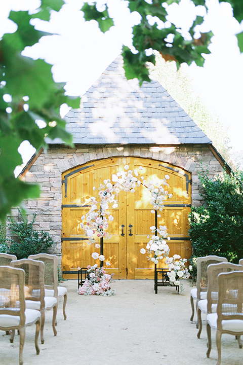  a gold and navy wedding at kestrel park with the groom in a navy tuxedo and the bride in a lace ballgown with long sleeves 