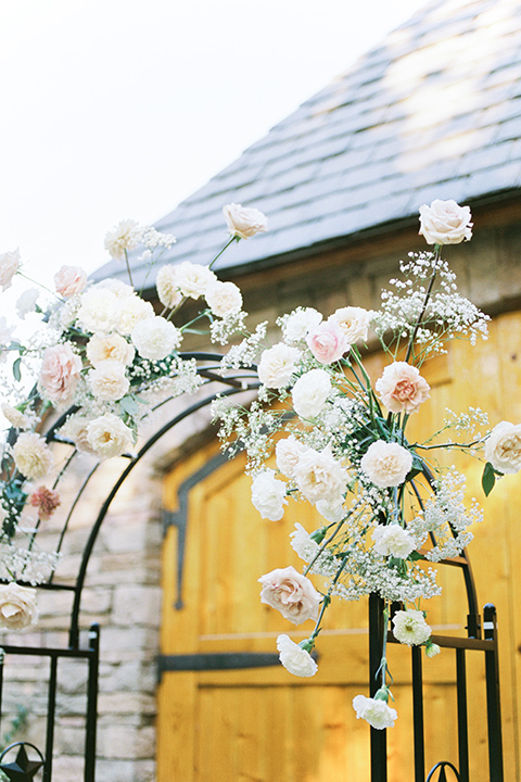  a gold and navy wedding at kestrel park with the groom in a navy tuxedo and the bride in a lace ballgown with long sleeves 