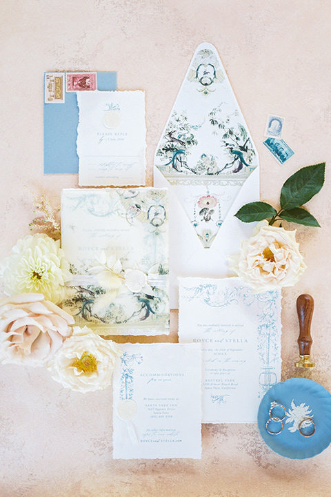  a gold and navy wedding at kestrel park with the groom in a navy tuxedo and the bride in a lace ballgown with long sleeves 