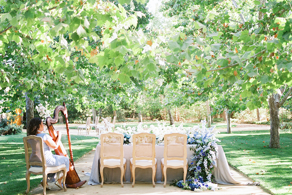  a gold and navy wedding at kestrel park with the groom in a navy tuxedo and the bride in a lace ballgown with long sleeves 