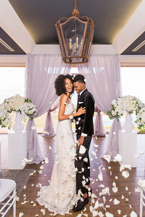  Las Vegas wedding with purple details and the bride in a strapless gown and the groom in a black velvet tuxedo 