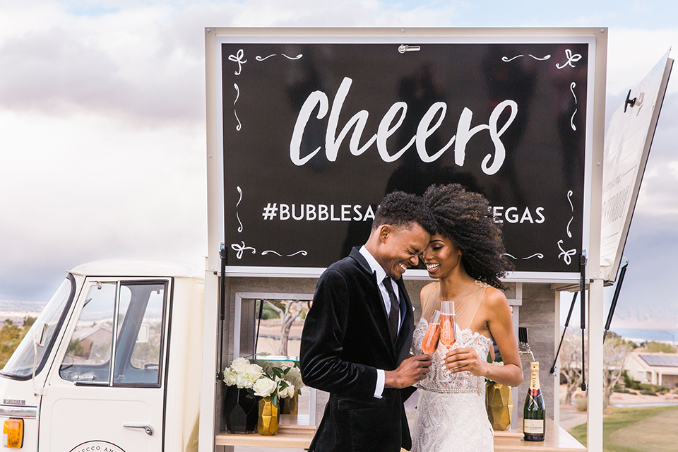  Las Vegas wedding with purple details and the bride in a strapless gown and the groom in a black velvet tuxedo 